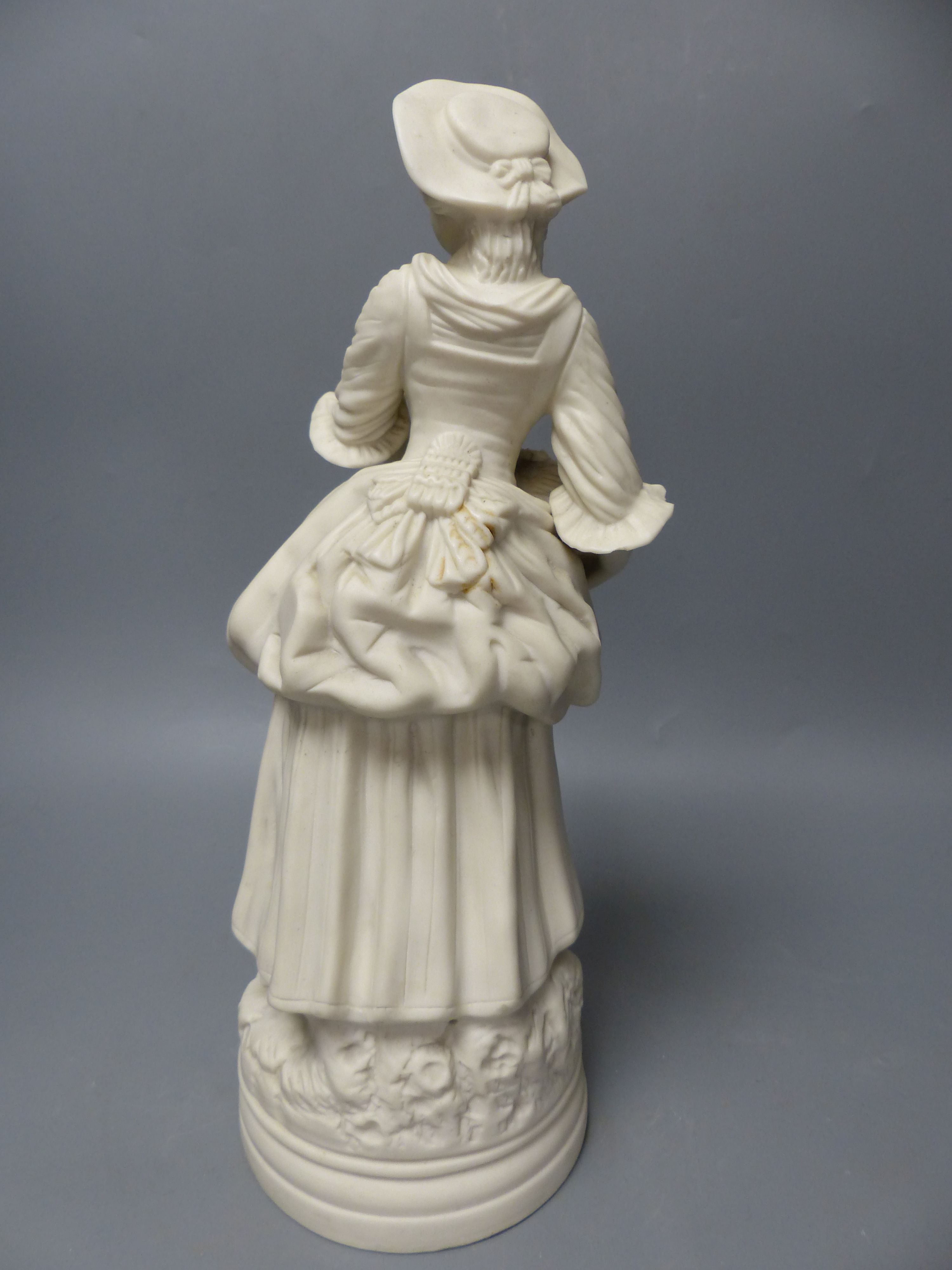 A 19th century Minton parian figure of Miranda and a Continental parian figure of a lady holding a basket, tallest 40cm